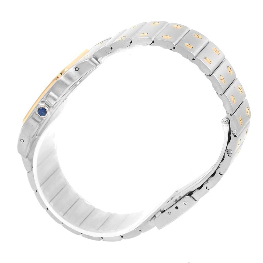 This image shows a side view of a Santos model watch by Cartier, highlighting its bracelet and crown with a blue gemstone.