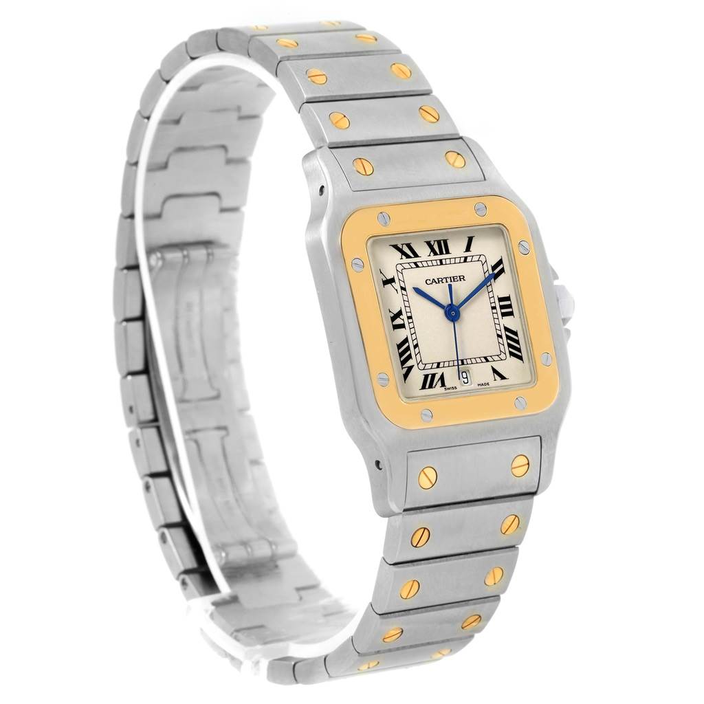 The image shows a Santos model watch by Cartier angled slightly from the top, displaying the face, bezel, and part of the bracelet.