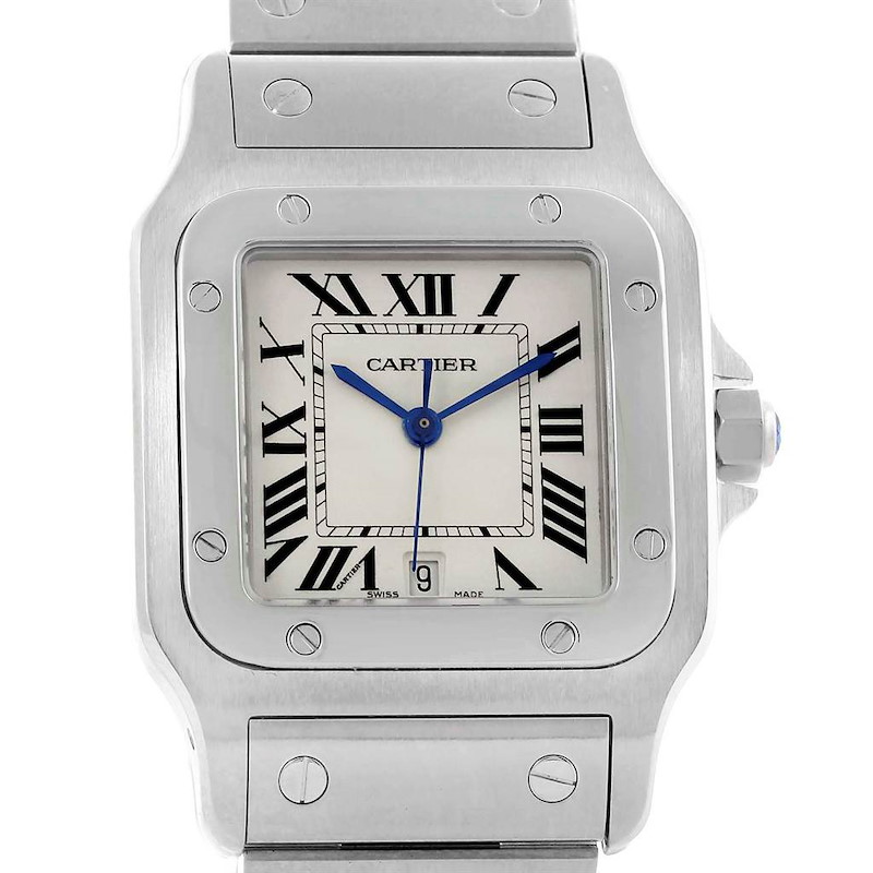 This image shows a face-on view of a Santos model Cartier watch, highlighting its white dial, Roman numerals, and metal bracelet.