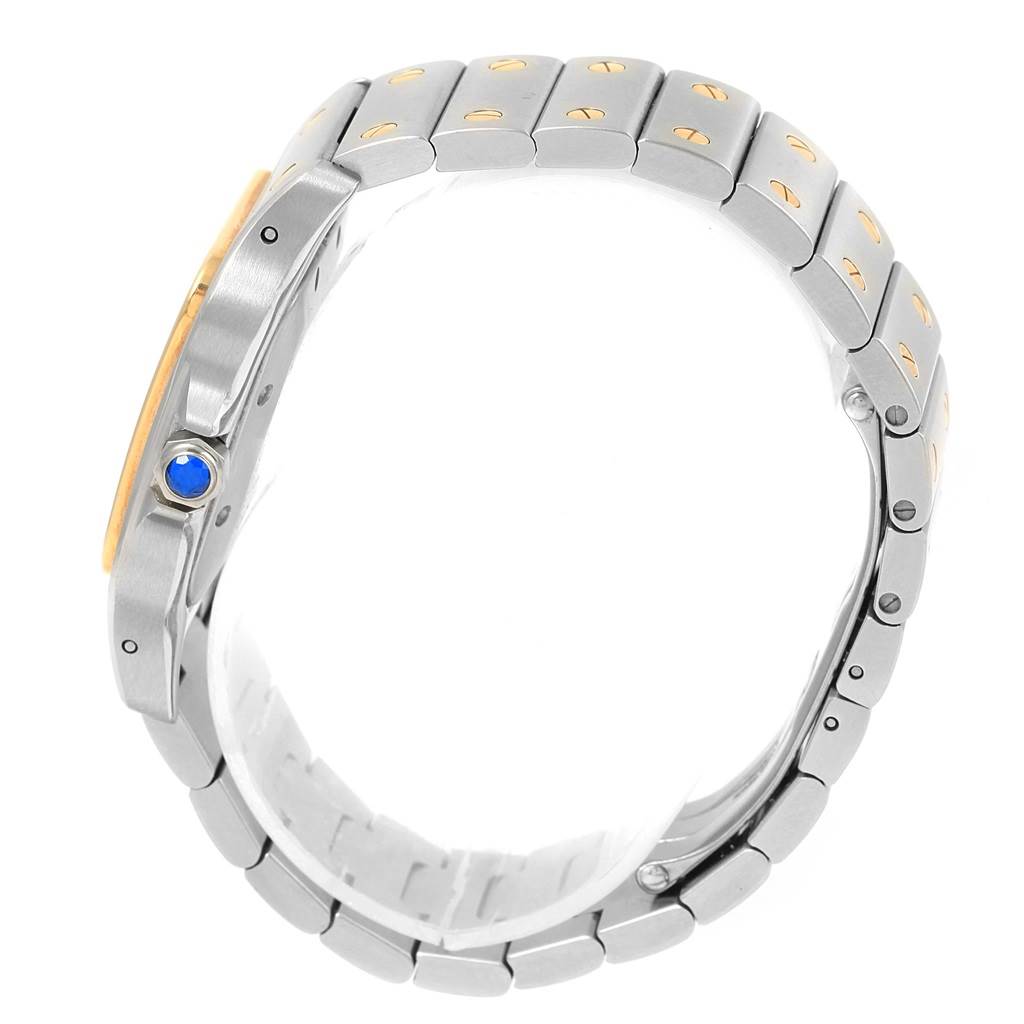 The image shows a side view of a Santos model watch by Cartier, focusing on the bracelet and crown with a blue gem.