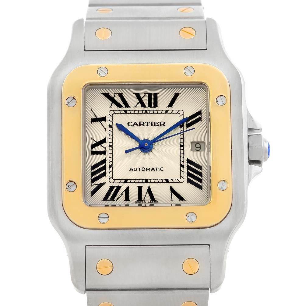 The image shows a close-up of the Cartier Santos W20058C4 Men
s Stainless Steel Silver Dial W20058C4 Men
s Stainless Steel Silver Dial watch with a focus on its face, bezel, and part of its strap.