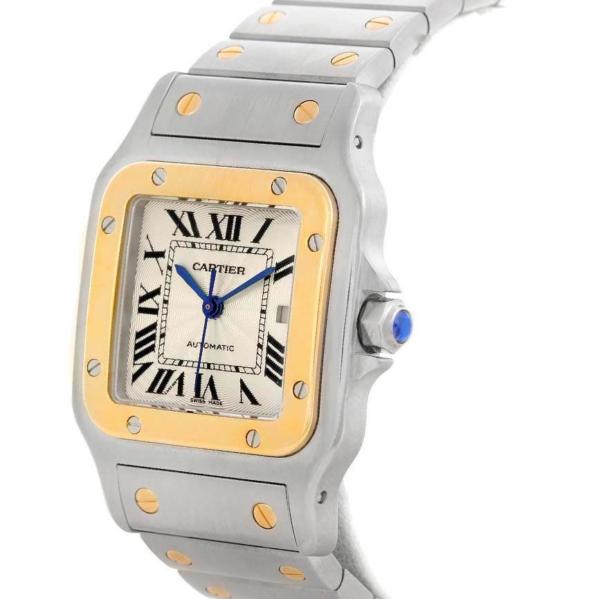 The image shows a side angle of a Cartier Santos W20058C4 Men
s Stainless Steel Silver Dial W20058C4 Men
s Stainless Steel Silver Dial watch featuring its face, bezel, crown, and part of the bracelet.