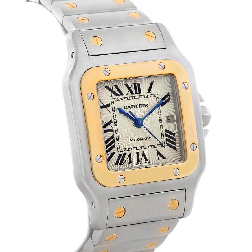 The image shows a close-up, angled view of the face and bracelet of the Santos model by Cartier.
