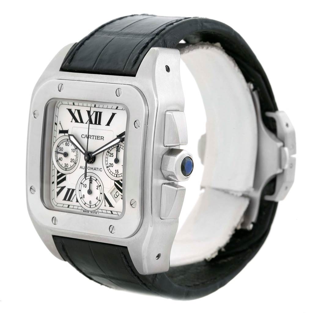 The image shows a Cartier Santos W20090X8 Men
s Stainless Steel Silver Dial W20090X8 Men
s Stainless Steel Silver Dial watch angled to display its face, side crown with blue gem, and black leather strap.