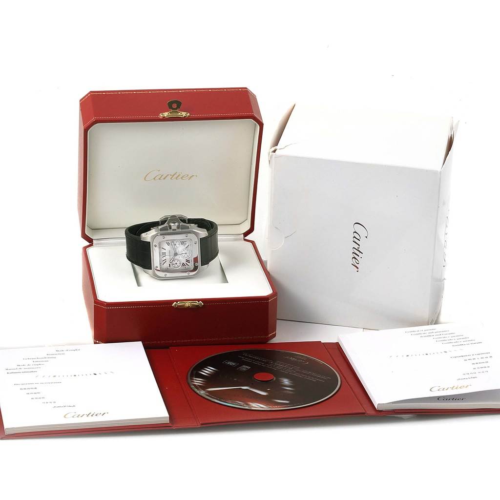 The image shows a Cartier Santos W20090X8 Men
s Stainless Steel Silver Dial W20090X8 Men
s Stainless Steel Silver Dial watch in its open red box, accompanied by documentation, a CD, and an outer white box.