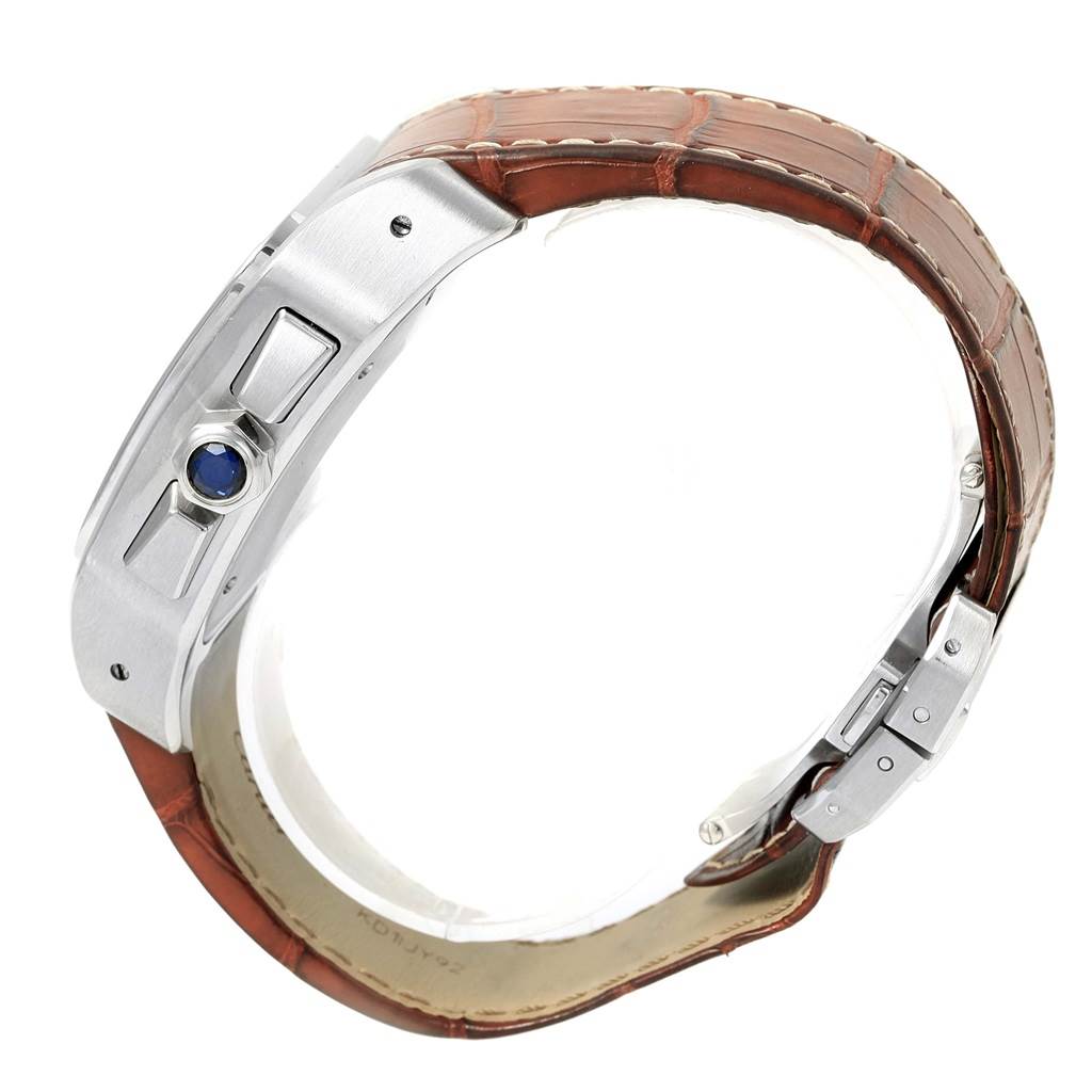 The image shows a side angle of a Cartier Santos W20090X8 Men
s Stainless Steel Silver Dial W20090X8 Men
s Stainless Steel Silver Dial watch, highlighting a brown leather strap and a blue cabochon crown.
