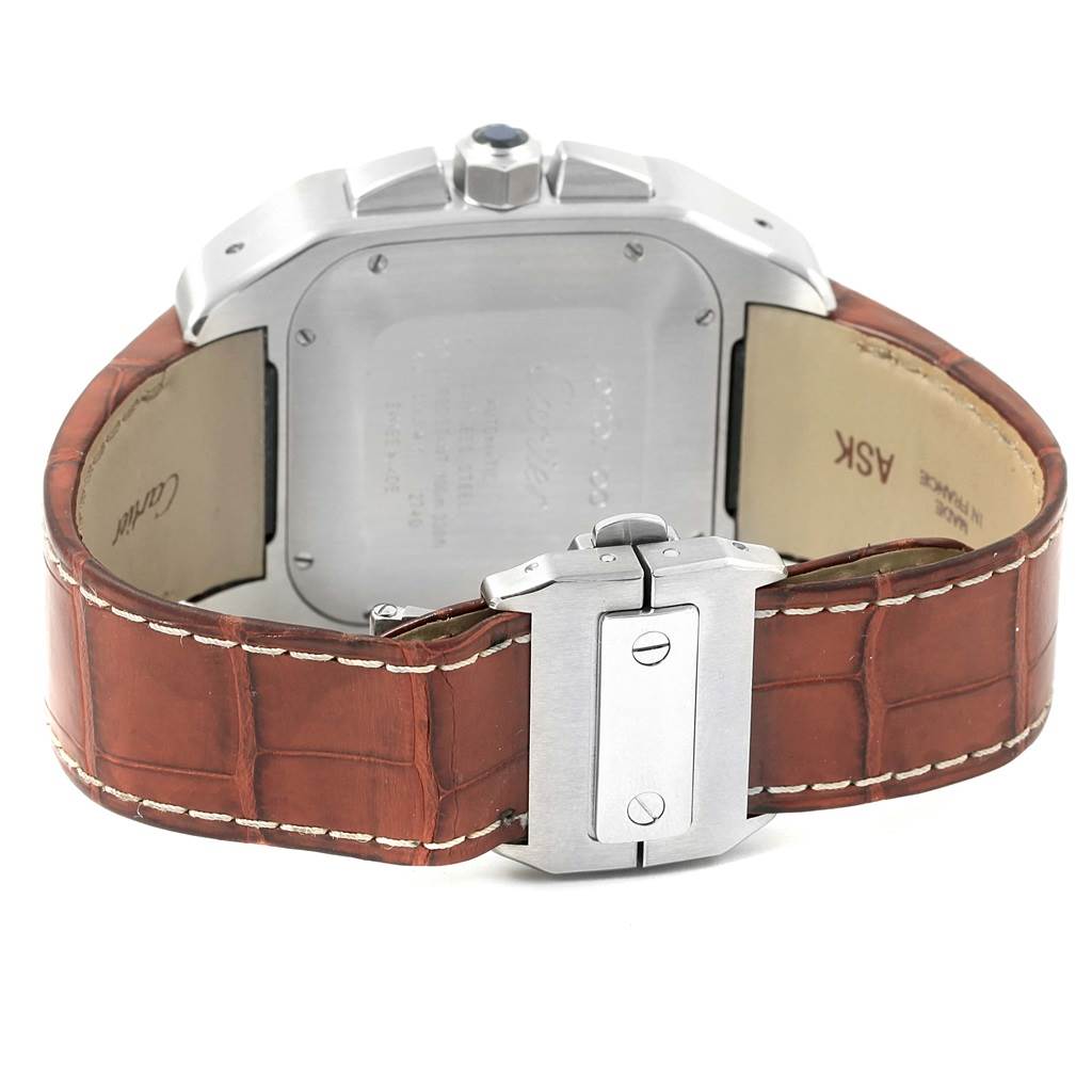 This image shows the back of a Cartier Santos W20090X8 Men
s Stainless Steel Silver Dial W20090X8 Men
s Stainless Steel Silver Dial watch and its brown leather strap with a deployment clasp.