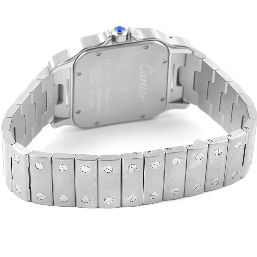 The image shows the back and bracelet of a Santos model watch by Cartier, highlighting its stainless steel links and screws.