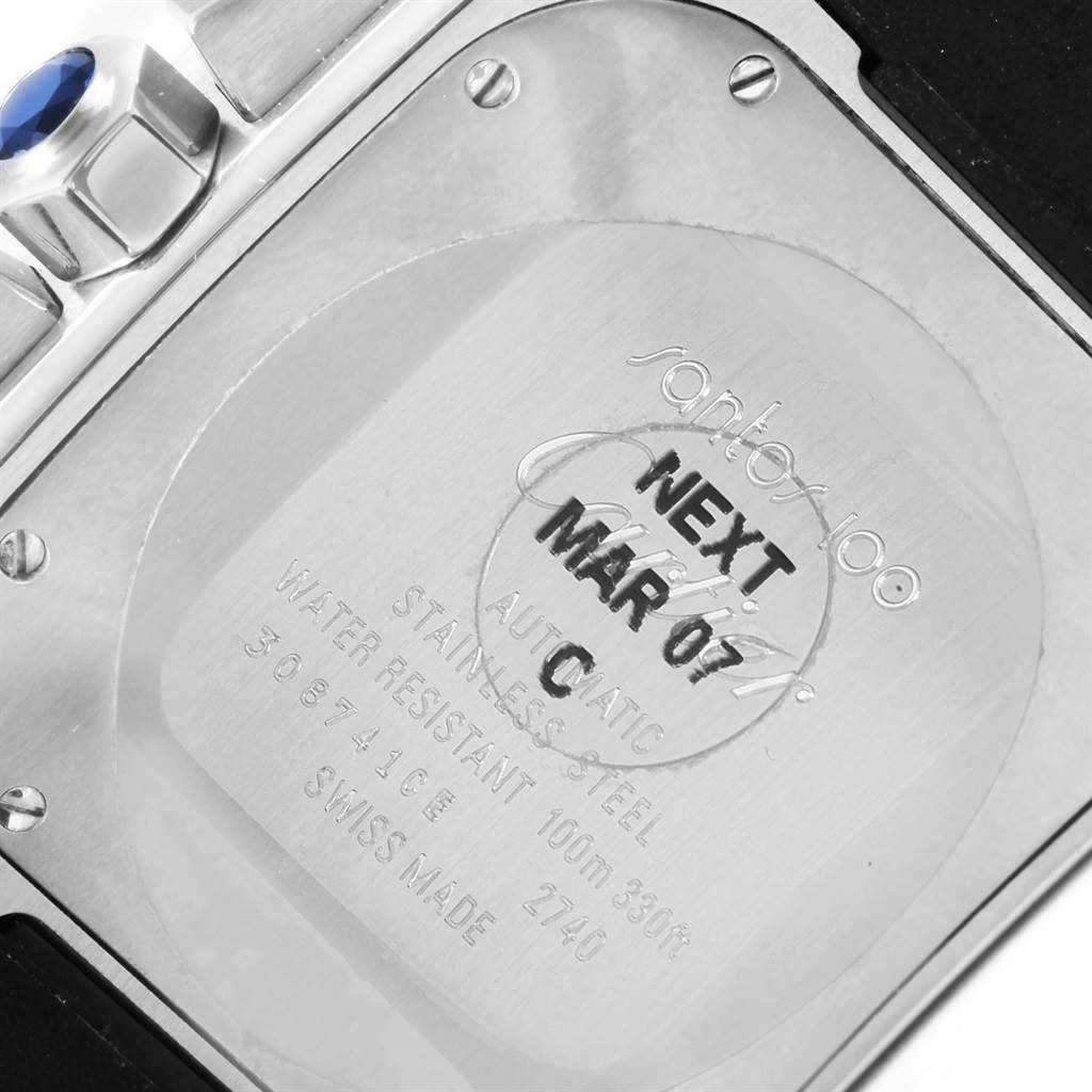 The image shows the back case of a Santos model watch by Cartier, focusing on the engravings and screws.