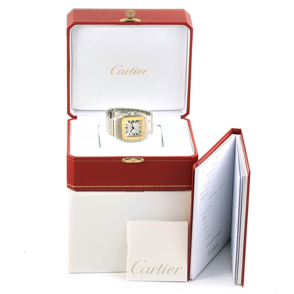 The Cartier Santos W20099C4 Men's Stainless Steel Silver Dial W20099C4 Men's Stainless Steel Silver Dial watch is displayed in its red box, accompanied by a booklet and warranty card.