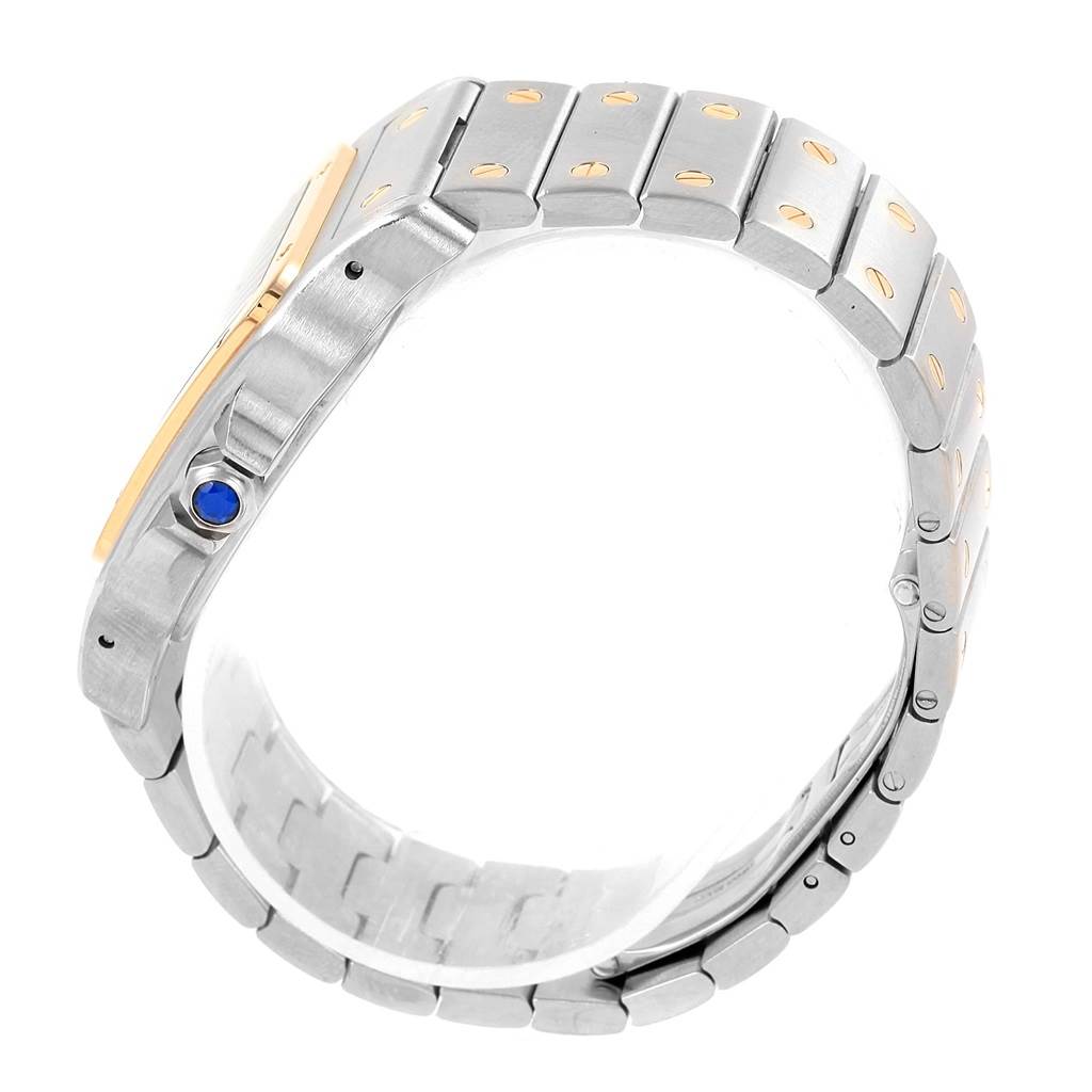 The image shows a side and partial profile view of the Cartier Santos W20099C4 Men's Stainless Steel Silver Dial W20099C4 Men's Stainless Steel Silver Dial watch, highlighting its bracelet and blue cabochon crown.