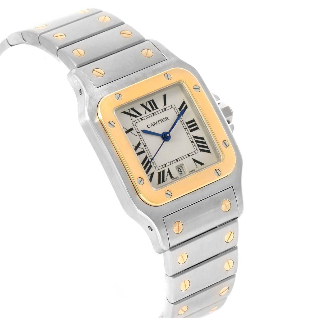 The Cartier Santos W20011C4 Stainless Steel Silver Dial W20011C4 Stainless Steel Silver Dial watch is shown from an angled top view, highlighting its square face, silver and gold accents, and linked bracelet.