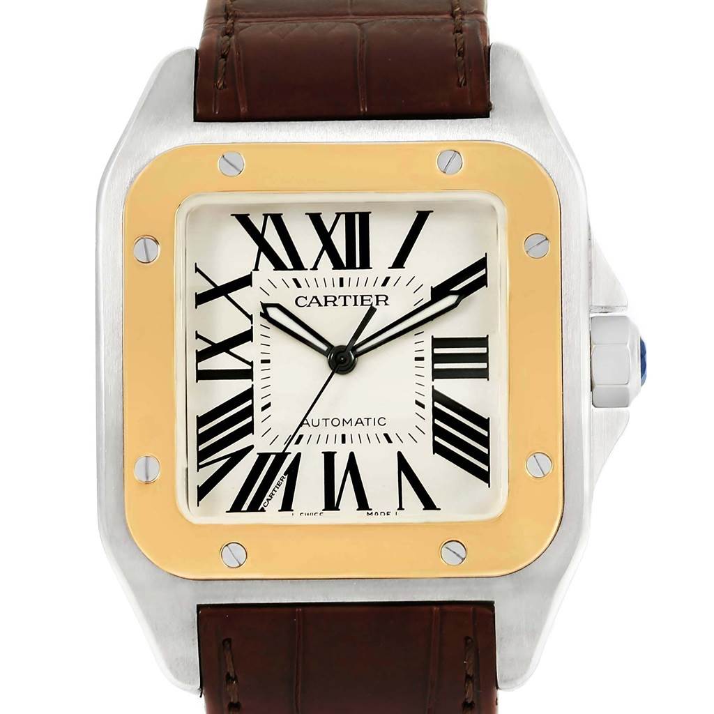 The image shows a front view of a Cartier Santos W20072X7 Men
s Stainless Steel Silver Dial W20072X7 Men
s Stainless Steel Silver Dial watch face and part of its brown leather strap.