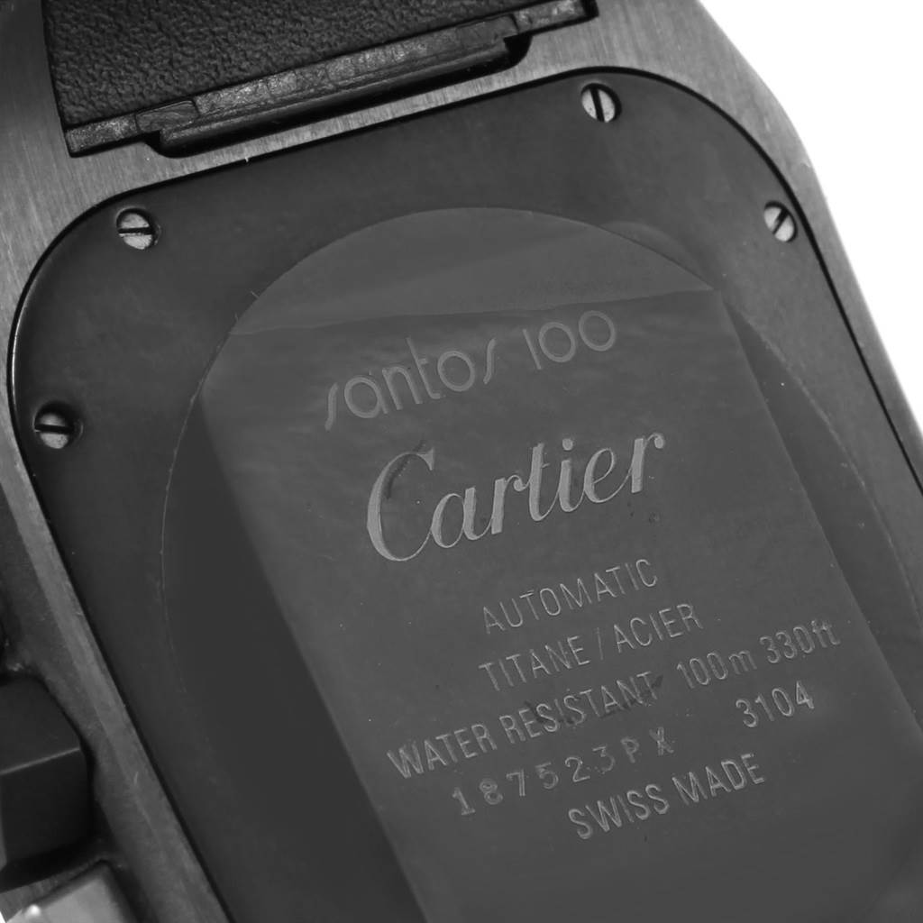 The image shows the back case of a Cartier Santos W2020005 Men's Titanium Black Dial W2020005 Men's Titanium Black Dial 100 watch, highlighting its engraved details.
