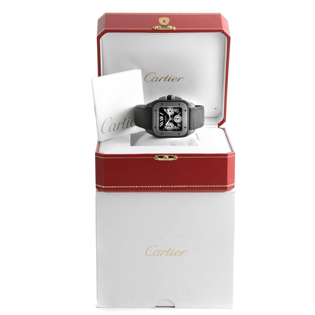 The image shows a Cartier Santos W2020005 Men's Titanium Black Dial W2020005 Men's Titanium Black Dial watch from a frontal angle inside its red and white Cartier box, along with a booklet.