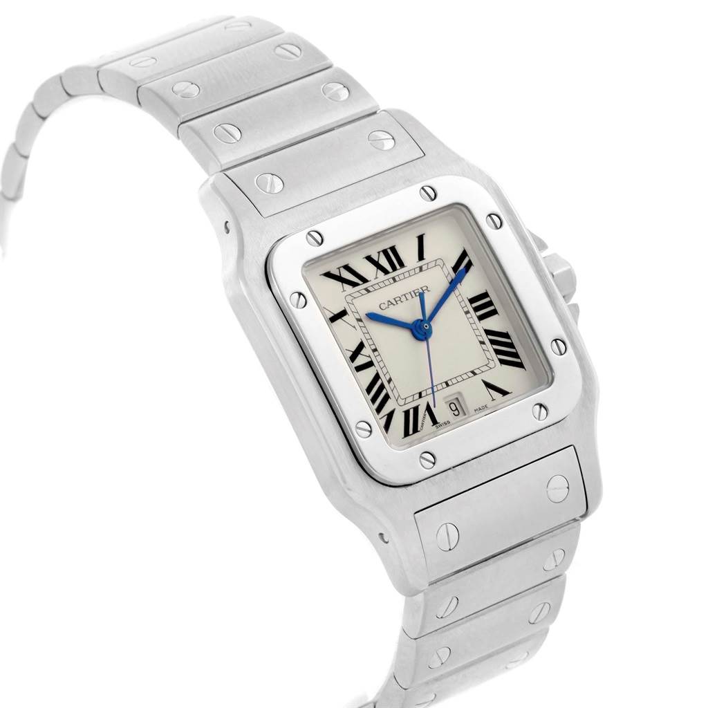 The image shows a close-up angled view of the Cartier Santos W20060D6 Stainless Steel Silver Dial W20060D6 Stainless Steel Silver Dial watch, highlighting its face, blue hands, Roman numerals, and metal bracelet.
