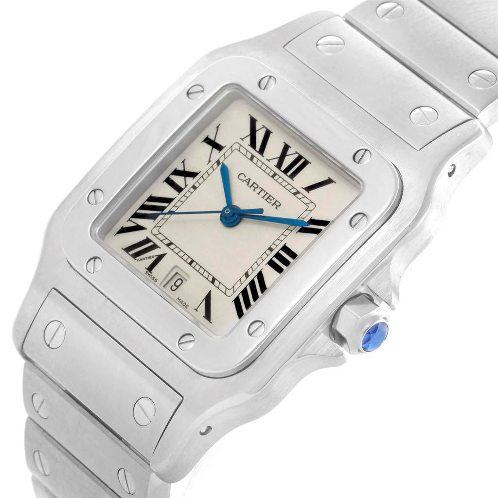 The Cartier Santos W20060D6 Stainless Steel Silver Dial W20060D6 Stainless Steel Silver Dial watch is shown at a slight angle, highlighting its square face, roman numeral dial, diamond-shaped crown, and linked bracelet.
