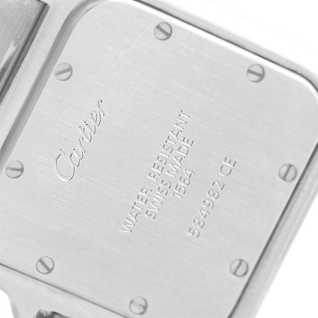 This image shows a close-up of the back casing of a Santos model by Cartier, highlighting its screws and engravings.