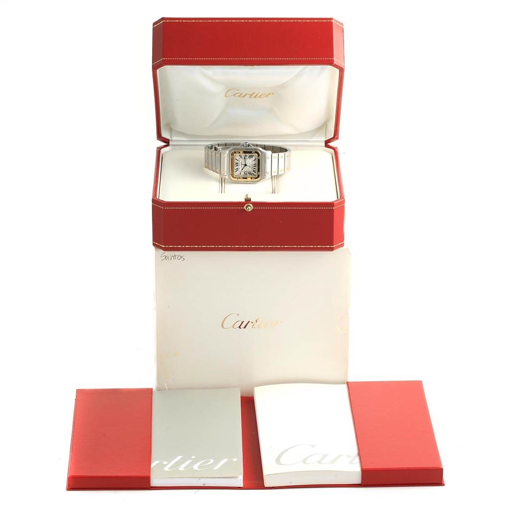 The image shows a Cartier Santos W20058C4 Men's Stainless Steel Silver Dial W20058C4 Men's Stainless Steel Silver Dial watch in its open display box, with accompanying booklets and packaging.
