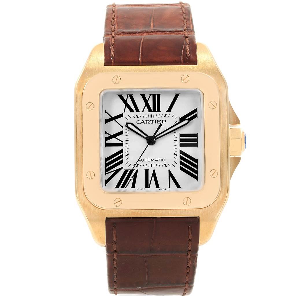 The image shows a front view of a Cartier Santos W20071Y1 Men's Yellow Gold Silver Dial W20071Y1 Men's Yellow Gold Silver Dial watch, highlighting its square gold case, white dial with Roman numerals, and brown leather strap.