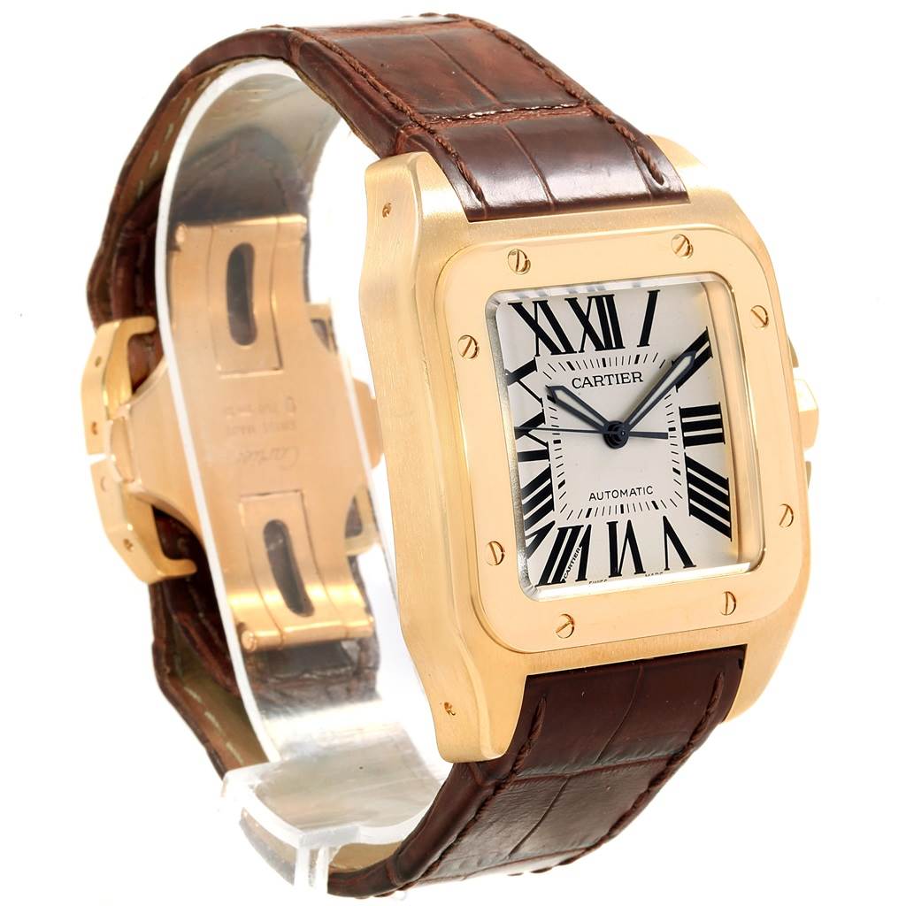 The image shows a Cartier Santos W20071Y1 Men's Yellow Gold Silver Dial W20071Y1 Men's Yellow Gold Silver Dial watch at a slight angle, highlighting its gold case, Roman numeral dial, and brown leather strap.