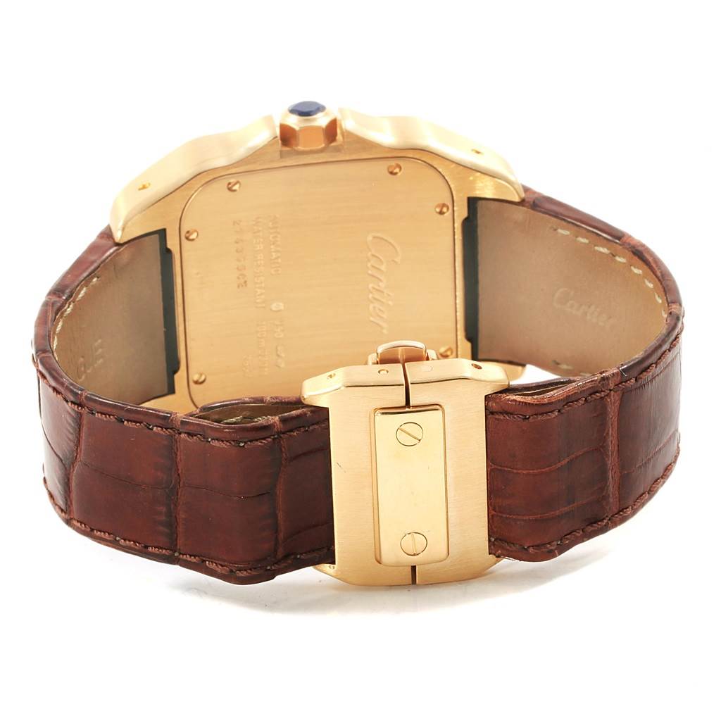 The image shows the back of a Santos model watch by Cartier, highlighting the clasp and case back with brown leather straps.