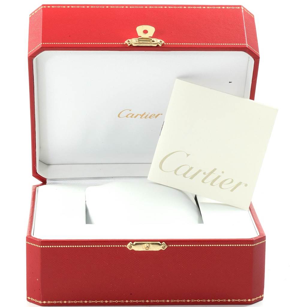 The image shows an open red Cartier box for the Santos model, featuring a white pillow and a Cartier booklet inside.
