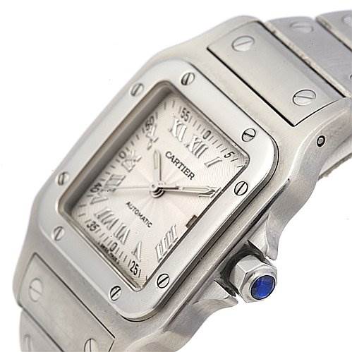 The image shows a close-up of the Santos model watch by Cartier, focusing on the face, bezel, and part of the bracelet.