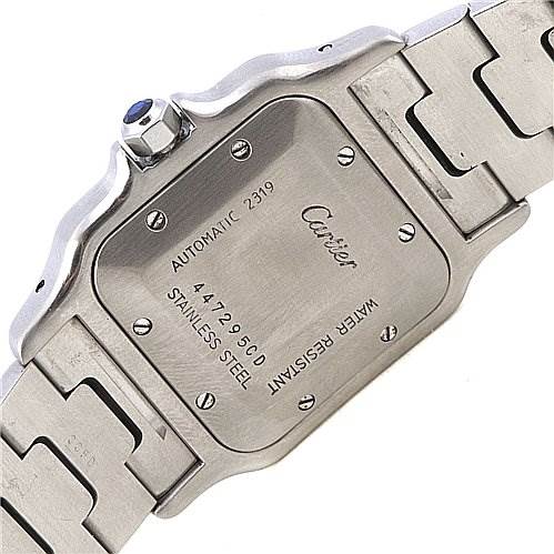 This image shows the back case and part of the bracelet of a Cartier Santos Stainless Steel Silver Dial Stainless Steel Silver Dial watch, highlighting its stainless steel construction and engraving.