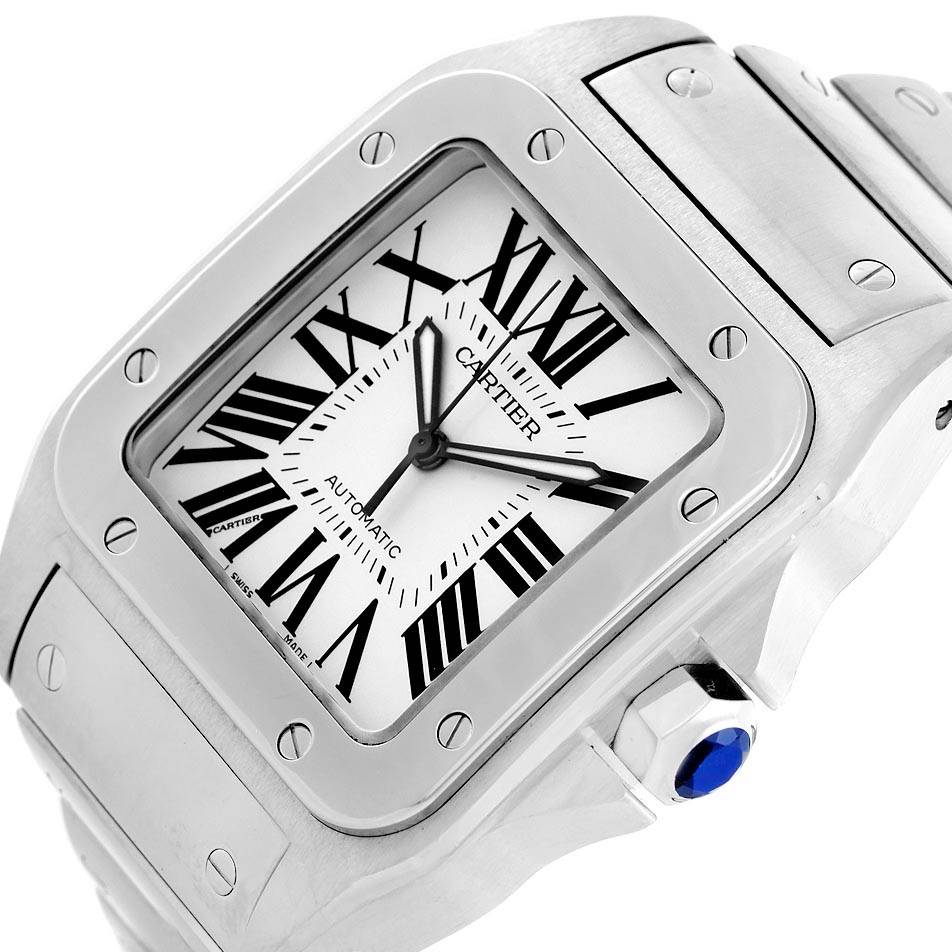The image shows a close-up angled view of a Santos model by Cartier, highlighting its face, bezel, and part of the bracelet, with a visible blue crown.