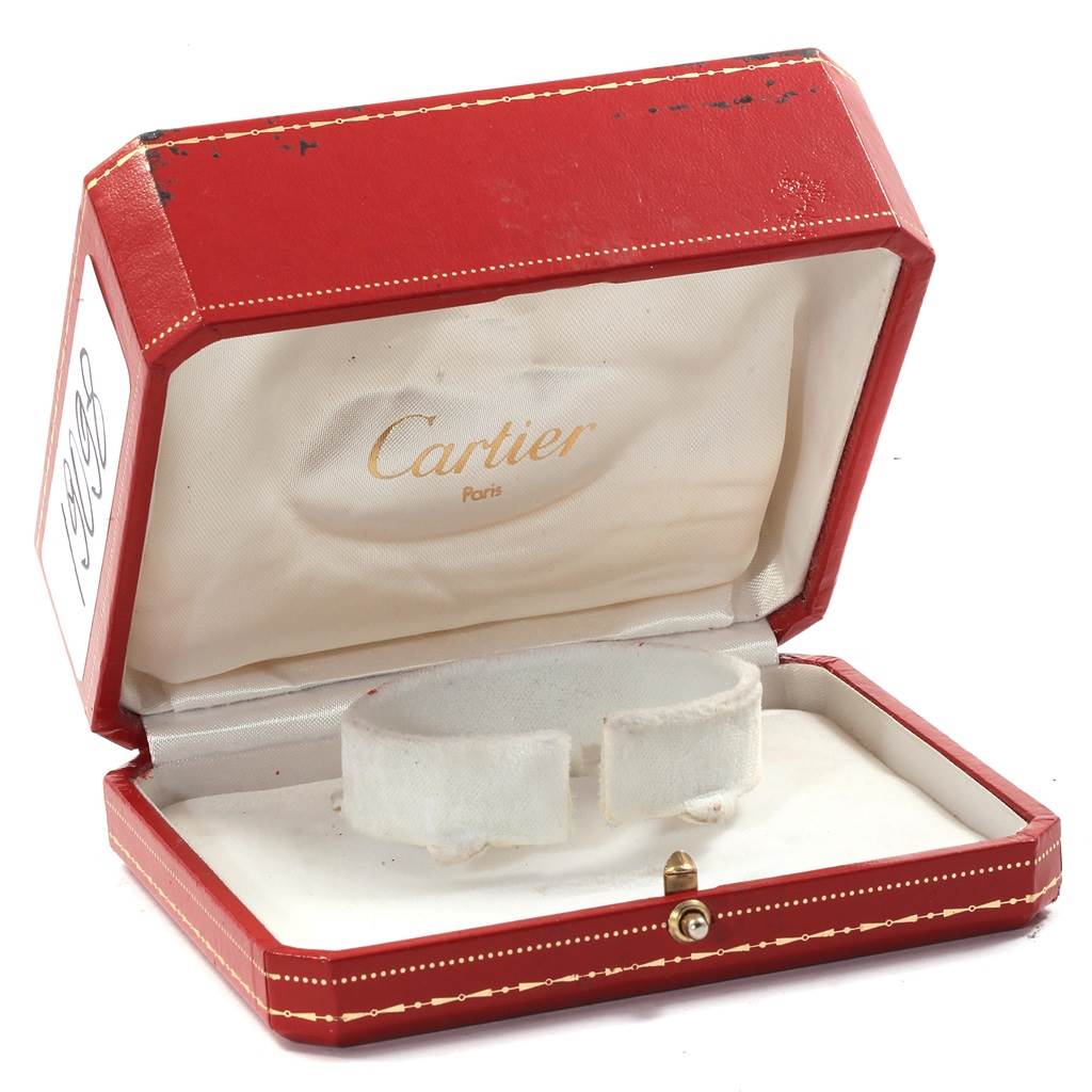 The image shows an open red Cartier watch box for the Santos model.
