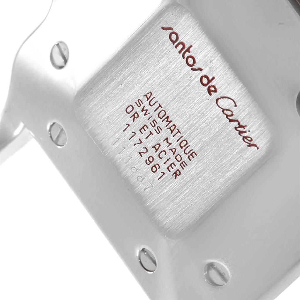 The image shows an angled view of the back case of a Santos de Cartier watch, displaying branding and model details.