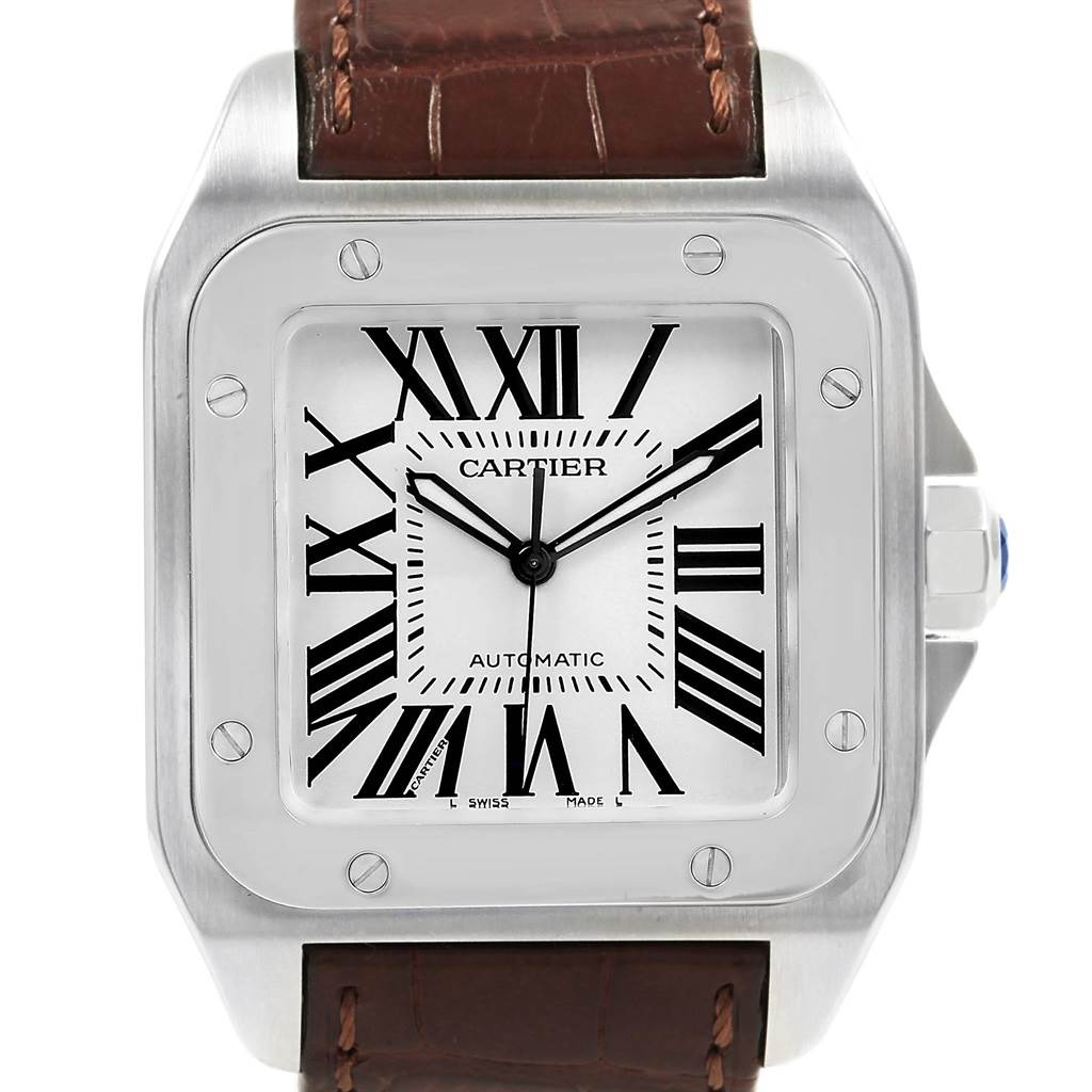 The image shows the front face and part of the strap of a Cartier Santos W20073X8 Men's Stainless Steel Silver Dial W20073X8 Men's Stainless Steel Silver Dial watch, highlighting its dial and bezel.
