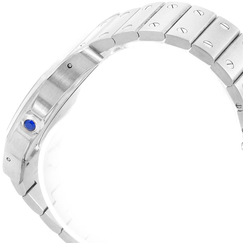 This image shows the side view of a Santos model by Cartier, focusing on its metal bracelet and crown with a blue gemstone.