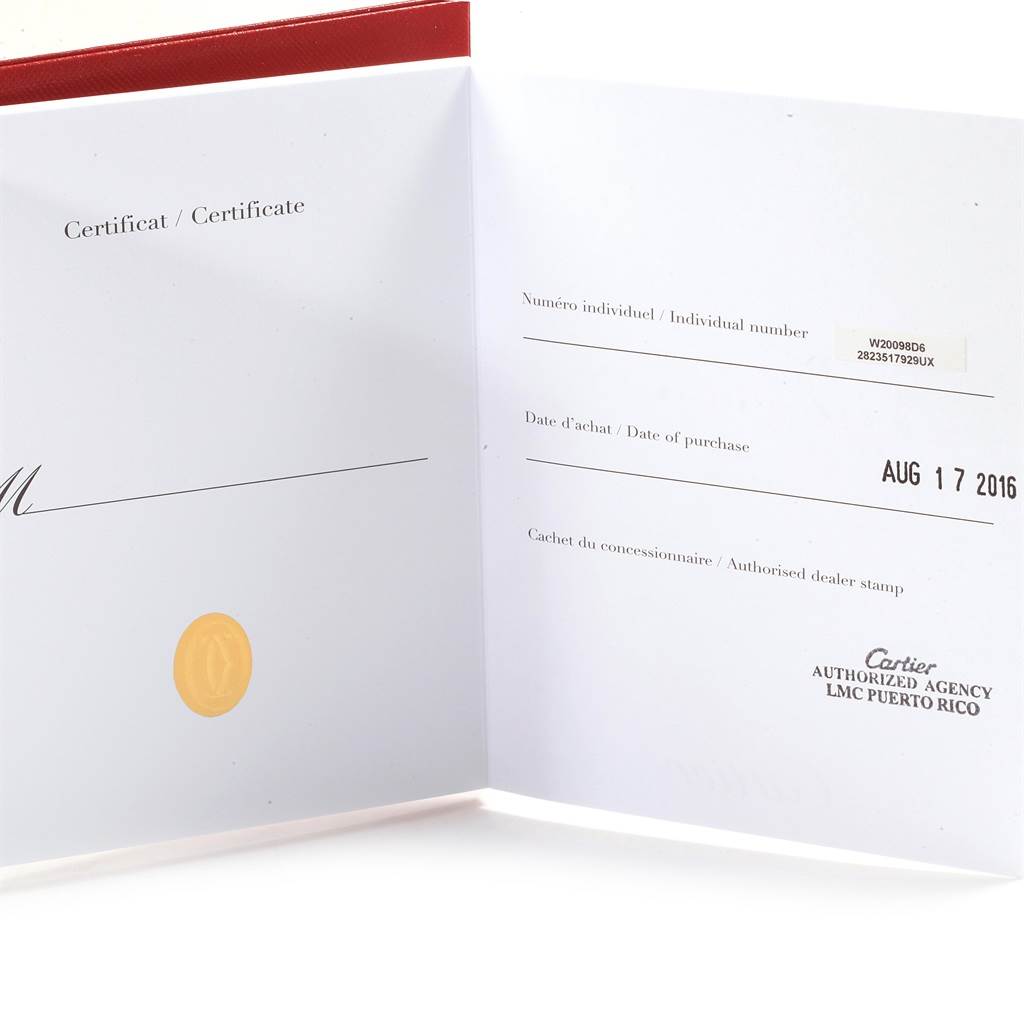 The image shows an open certificate booklet for a Santos model by Cartier.