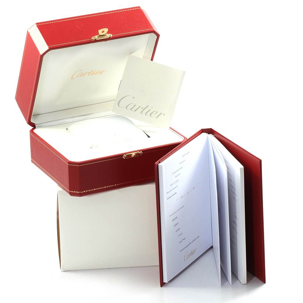 The image shows the Cartier Santos W20098D6 Men
s Stainless Steel Silver Dial W20098D6 Men
s Stainless Steel Silver Dial watch packaging, which includes a red box, an open document book, and an instruction manual.