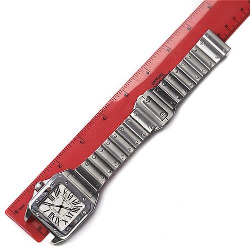 The Santos model by Cartier is shown laying flat, featuring the face, bezel, and full length of its metal bracelet.