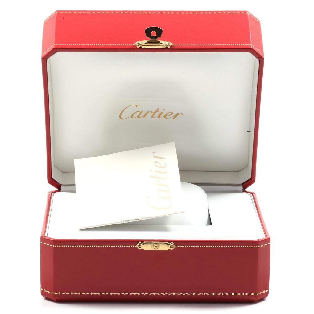 The image shows an angled view of an open Cartier box for the Santos model, displaying the booklet and inner packaging.