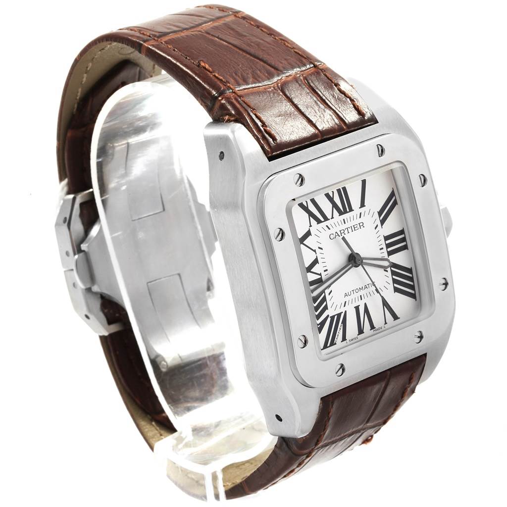 This Cartier Santos W20073X8 Men
s Stainless Steel Silver Dial W20073X8 Men
s Stainless Steel Silver Dial watch is shown at a three-quarter angle, displaying its face, case, and brown leather strap.