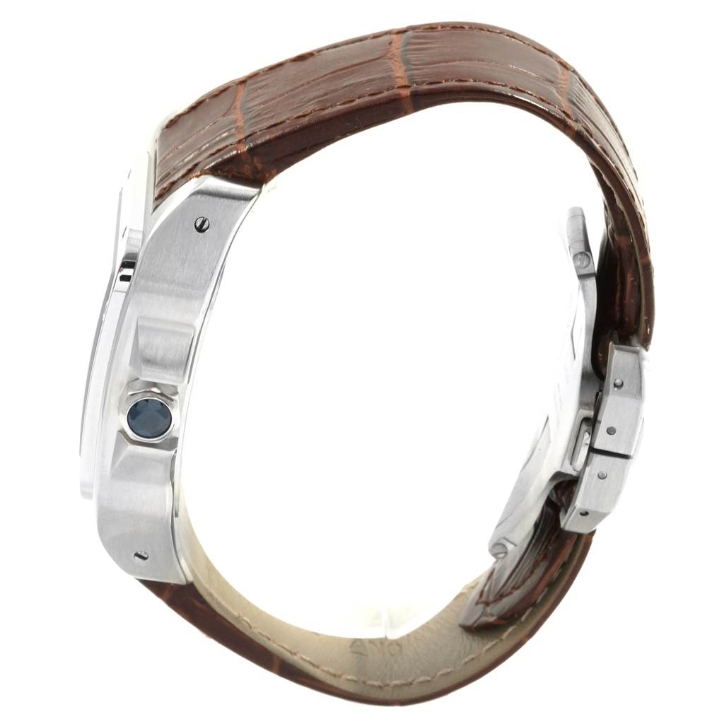 This image shows a side view of the Cartier Santos W20073X8 Men
s Stainless Steel Silver Dial W20073X8 Men
s Stainless Steel Silver Dial watch, highlighting its brown leather strap and the blue cabochon crown.