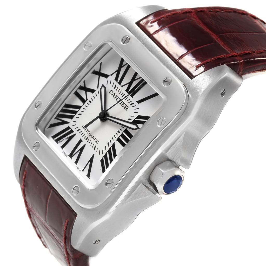 This image shows a close-up side view of the Cartier Santos W20073X8 Men's Stainless Steel Silver Dial W20073X8 Men's Stainless Steel Silver Dial watch, highlighting the dial, bezel, and crown with its signature blue gemstone.