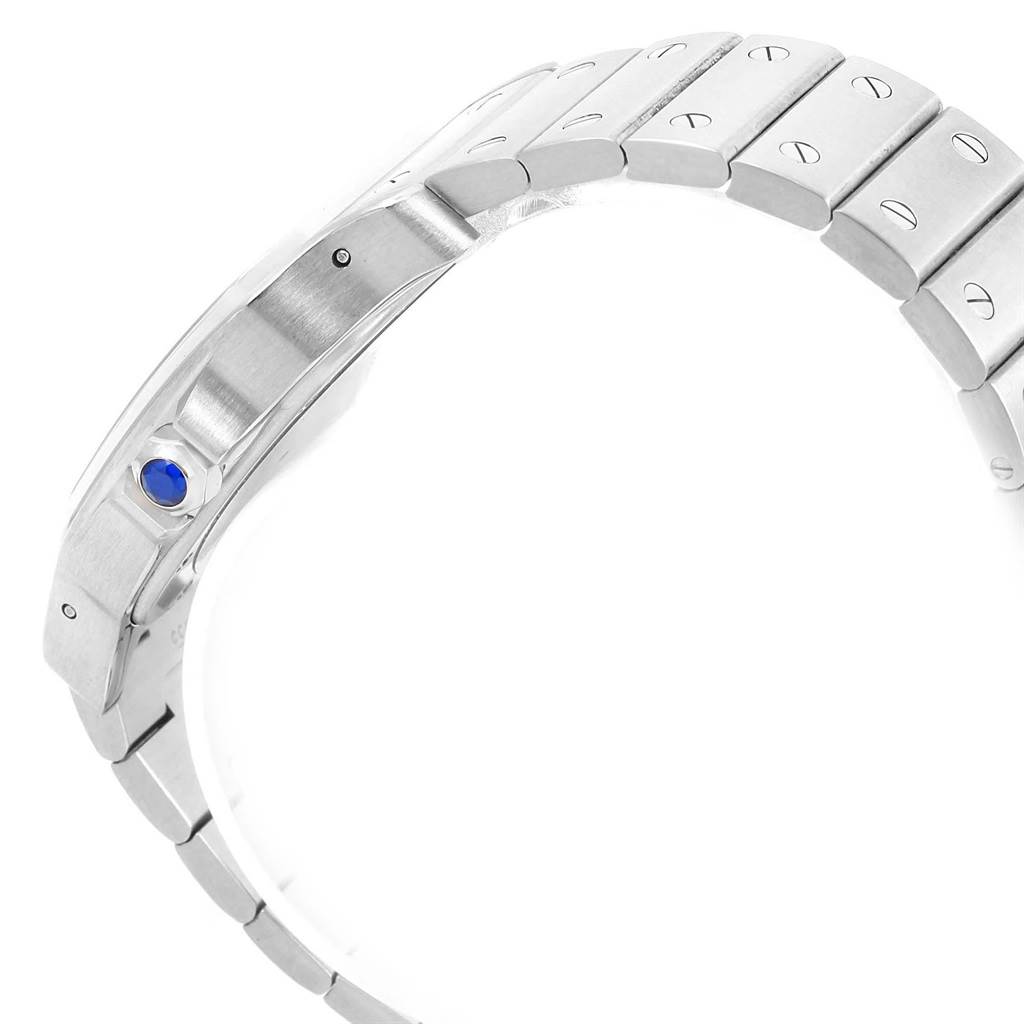 The image shows the side view of a Cartier Santos W20098D6 Men
s Stainless Steel Silver Dial W20098D6 Men
s Stainless Steel Silver Dial watch bracelet, highlighting the blue cabochon on the crown and metal links with screws.