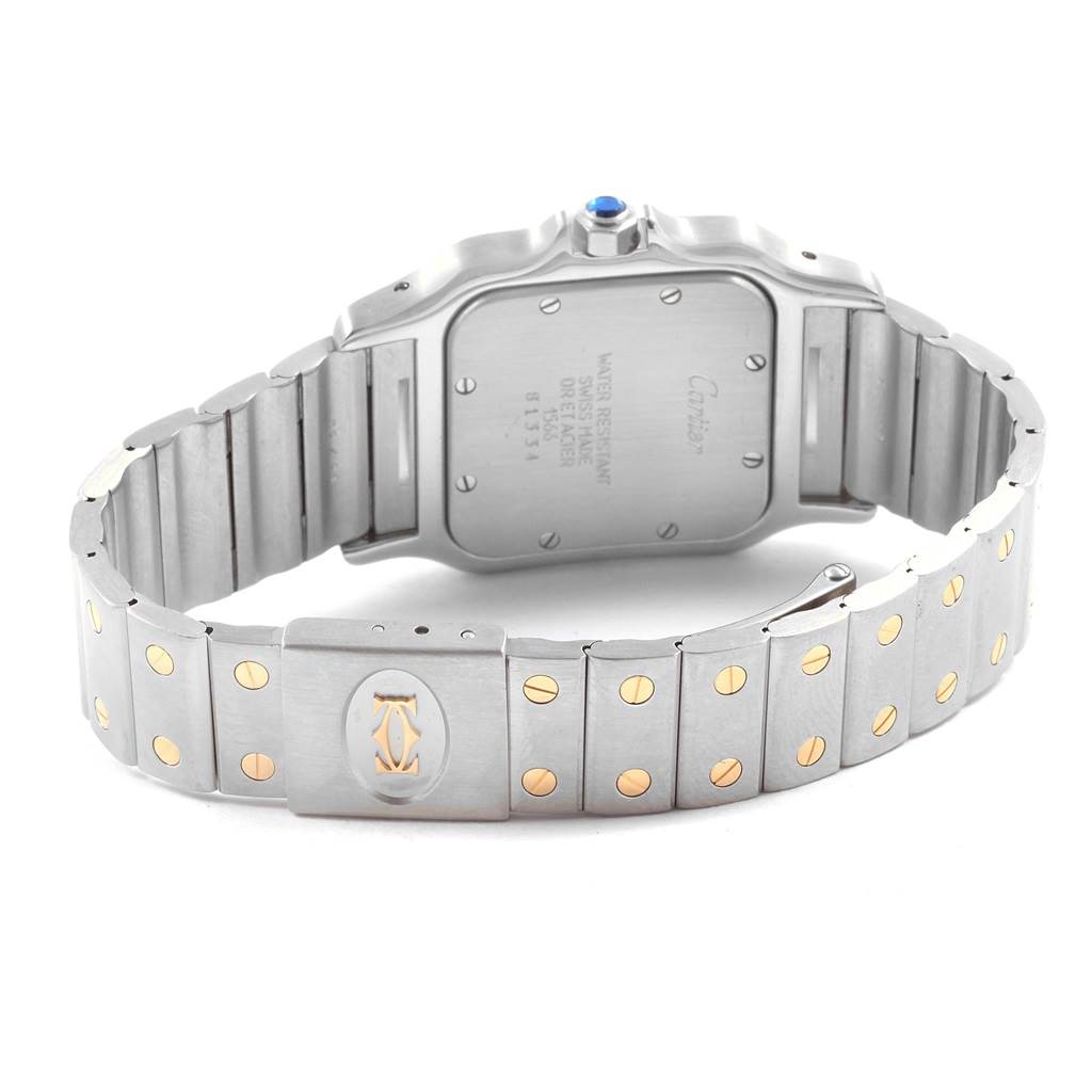 The image shows the back view of a Santos model watch by Cartier, focusing on the case back and bracelet.