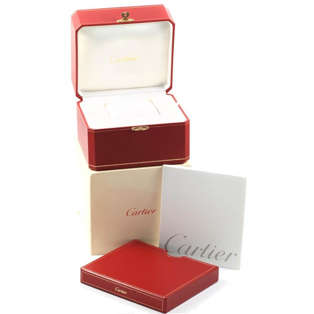 The image shows a red Cartier Santos W20073X8 Men's Stainless Steel Silver Dial W20073X8 Men's Stainless Steel Silver Dial watch box with an open lid, along with an outer box and an instruction booklet.