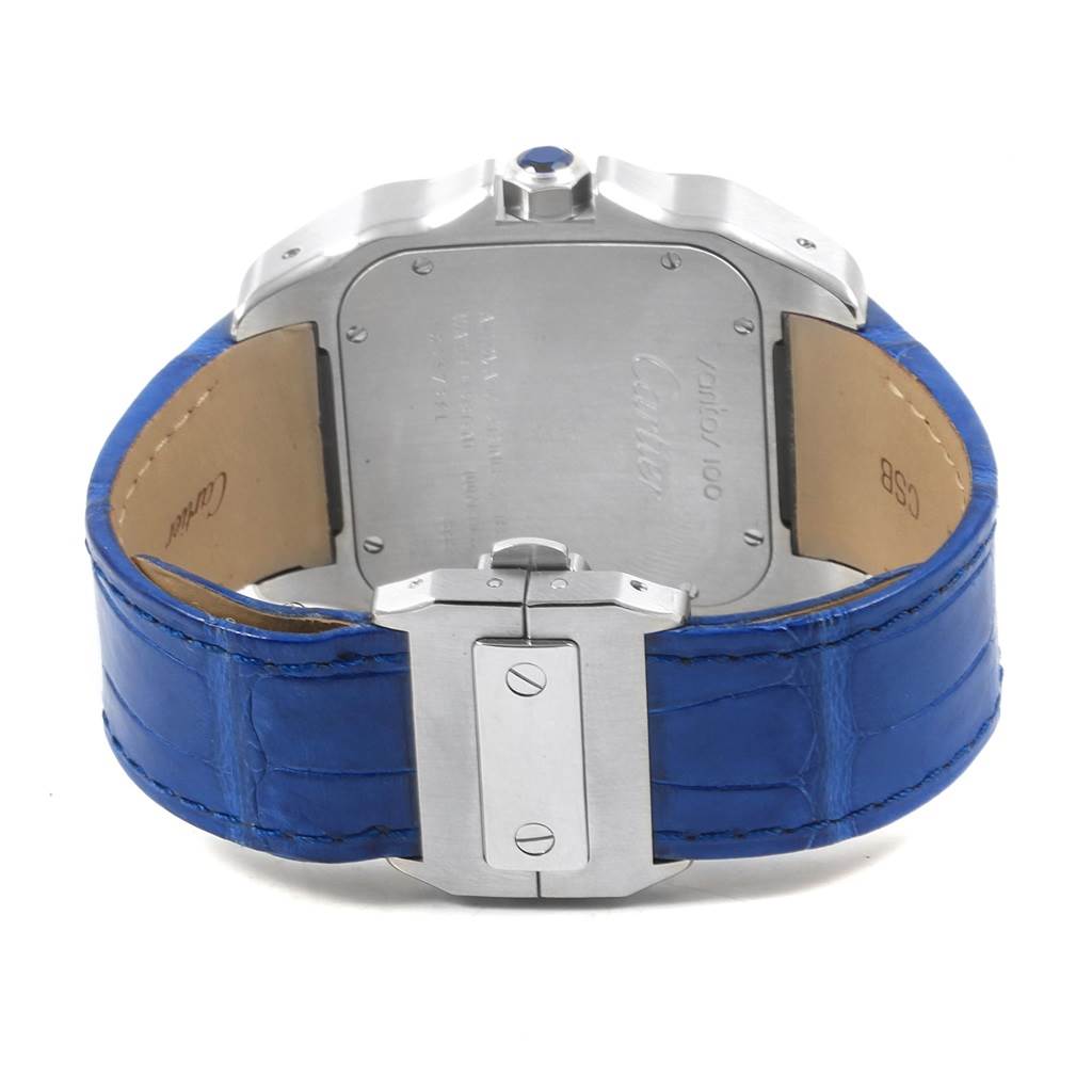 The image shows the back of a Cartier Santos W20073X8 Men
s Stainless Steel Silver Dial W20073X8 Men
s Stainless Steel Silver Dial watch with a blue leather strap and stainless steel case back and clasp.