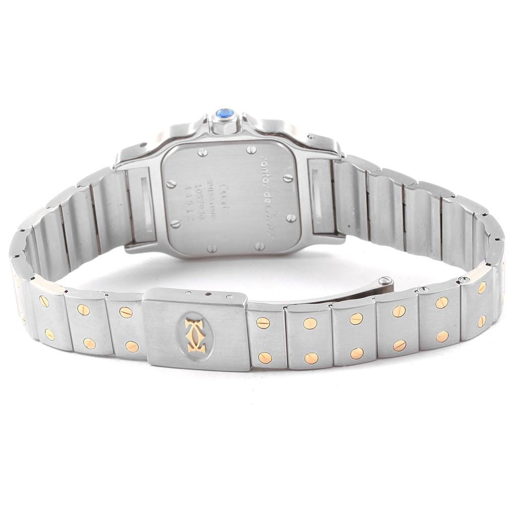 The image shows the back view of a Santos model by Cartier, including its case back and bracelet with visible screws and logo.
