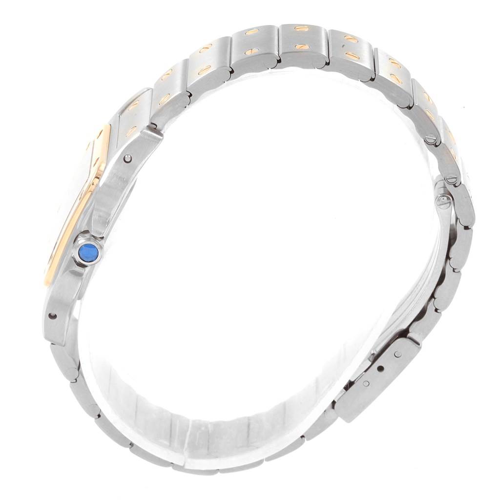 The image shows a side view of the Cartier Santos 1057930 Stainless Steel Grey Dial 1057930 Stainless Steel Grey Dial watch, highlighting its bracelet and crown with a blue gemstone.
