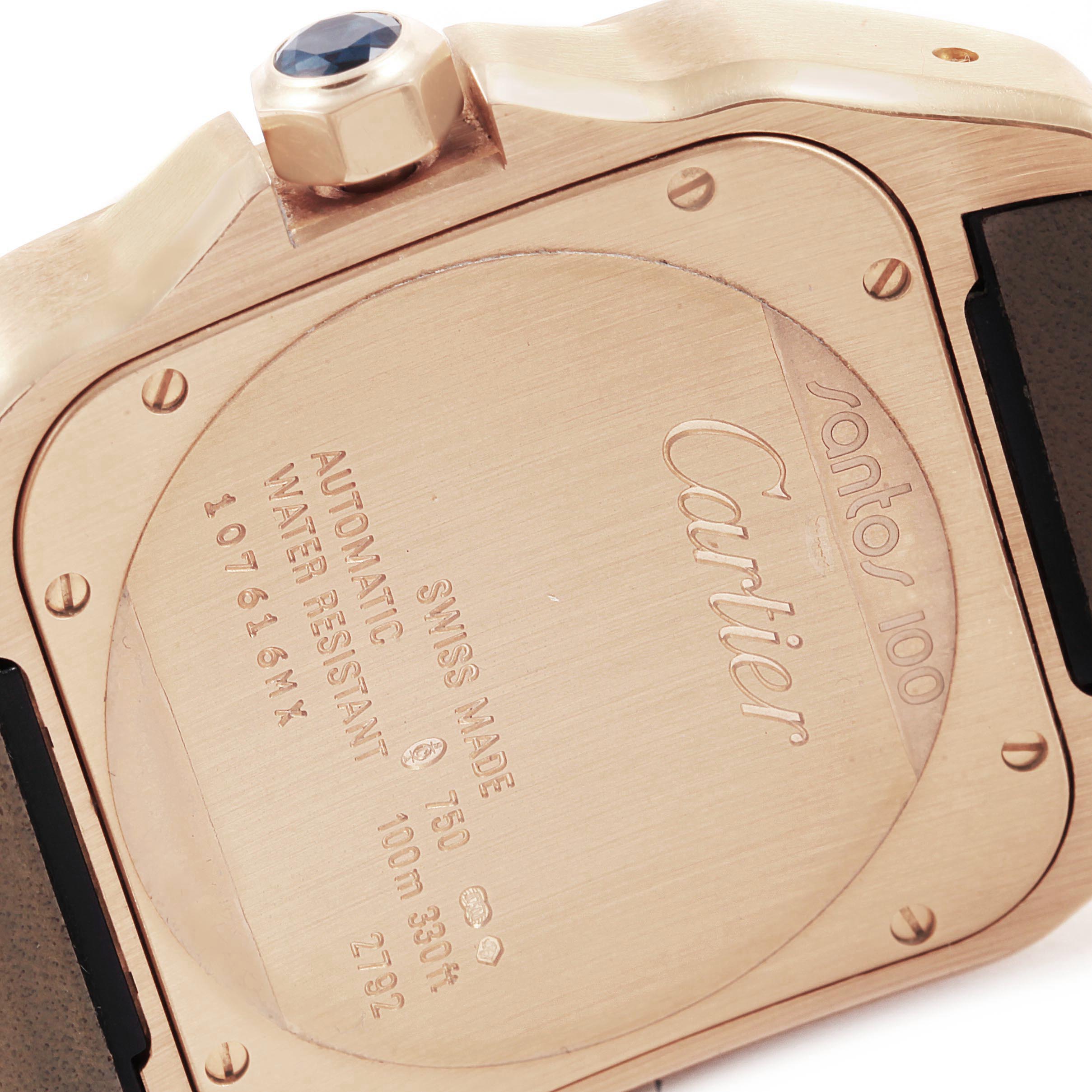 The image shows the case back and crown of a Santos 100 model watch by Cartier.
