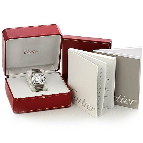 The image shows a Cartier Santos W20098D6 Stainless Steel Silver Dial W20098D6 Stainless Steel Silver Dial watch in its open red case, accompanied by instruction booklets.