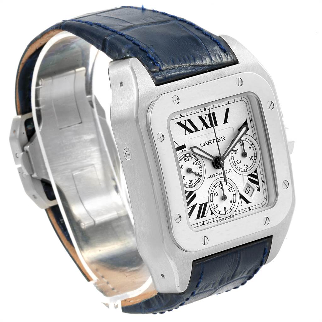 The image shows a Cartier Santos W20090X8 Men's Stainless Steel Silver Dial W20090X8 Men's Stainless Steel Silver Dial watch with a square face, Roman numerals, chronograph subdials, and a blue leather strap at an angled side view.